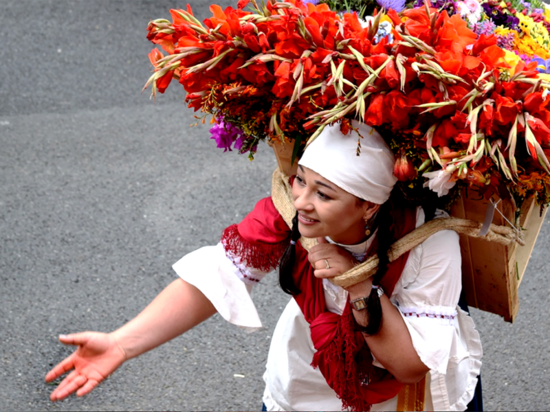 farmers carry silletas (large floral displays) in The Desfile de Silleteros (Parade of Flowers) during the Feria de las Flores is an annual festival in Colombia, South America