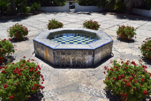 ceramic tile fountain and flowers in the courtyard of Casa del Herrero in Montecito, California