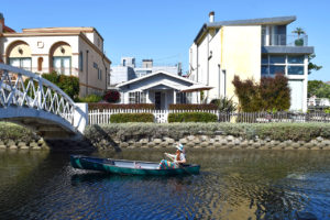 woman in a canoe at California’s Venice Canals in Venice, California