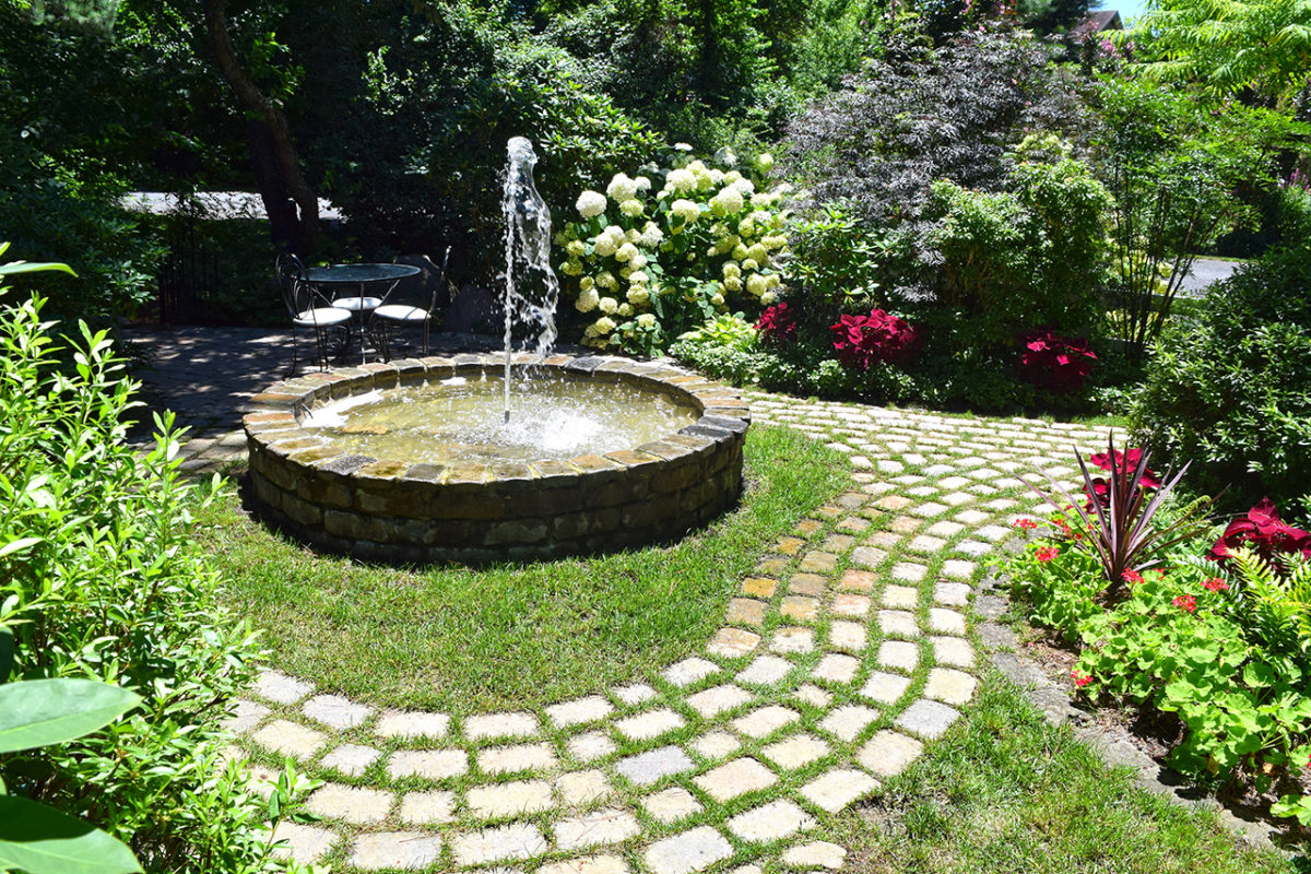 circular fountain and garden pathways at Mill Pond Garden in Lewes, Delaware