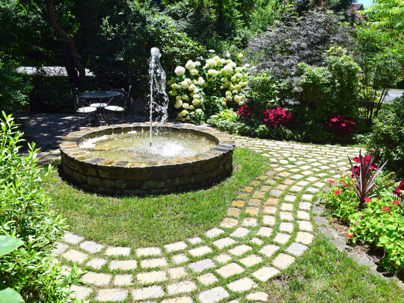 circular fountain and garden pathways at Mill Pond Garden in Lewes, Delaware